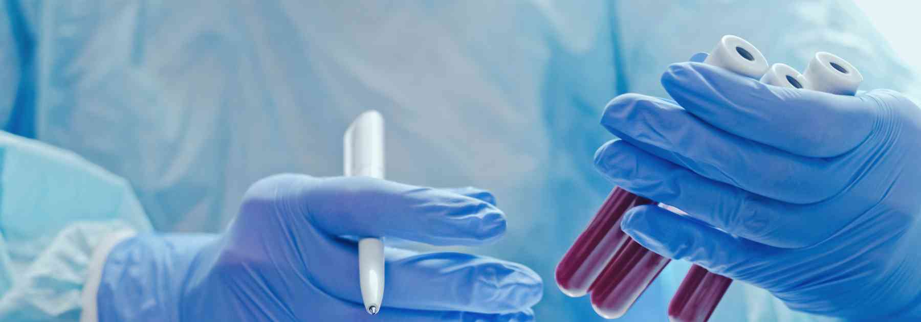 medical professional in laboratory looking at blood tests