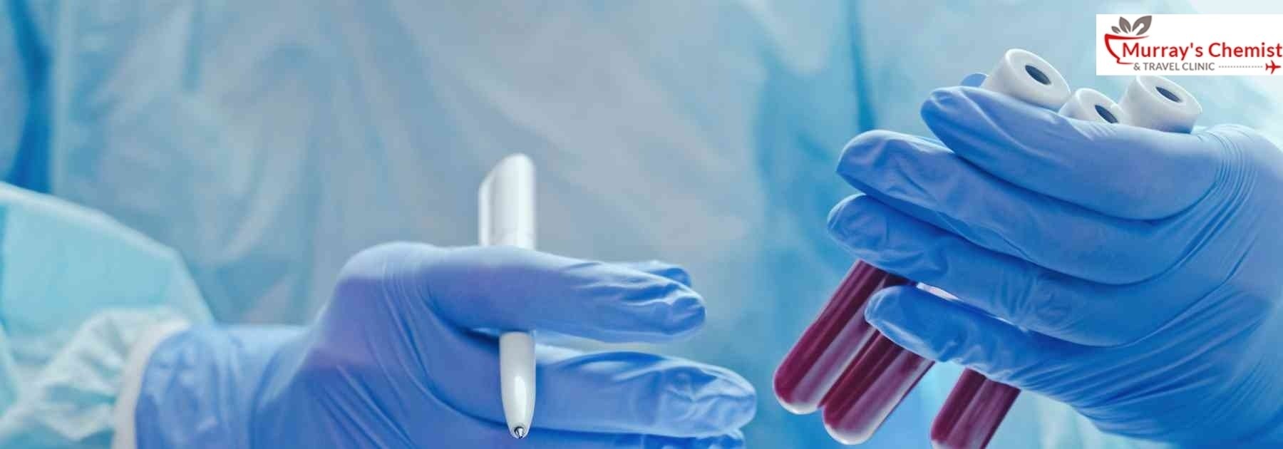 medical professional in laboratory looking at blood tests